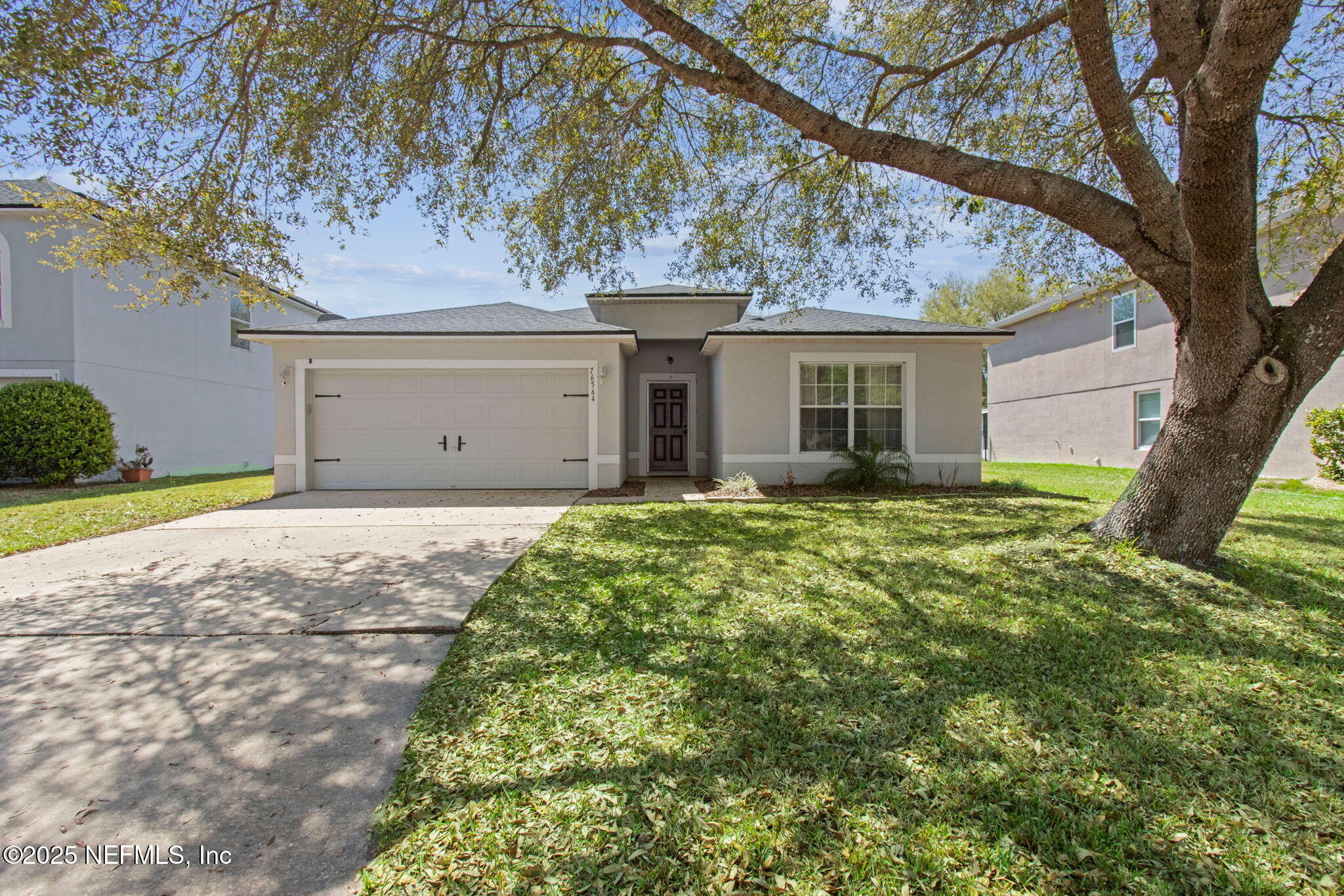 76564 Longleaf Loop Yulee, FL 32097 - Photo 7 of 54 a view of a house with a tree in a yard