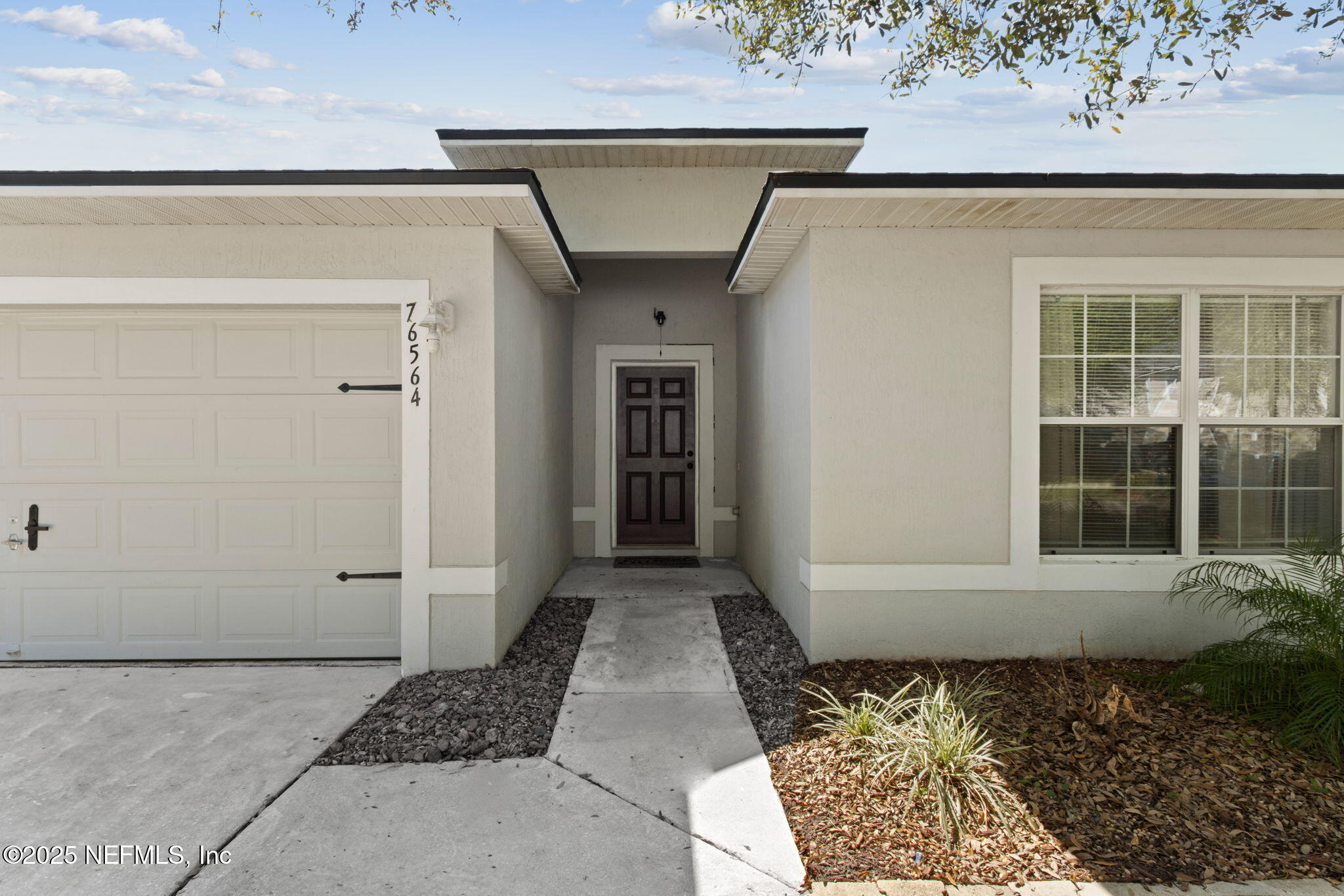 76564 Longleaf Loop Yulee, FL 32097 - Photo 8 of 54 a view of entrance gate of a house