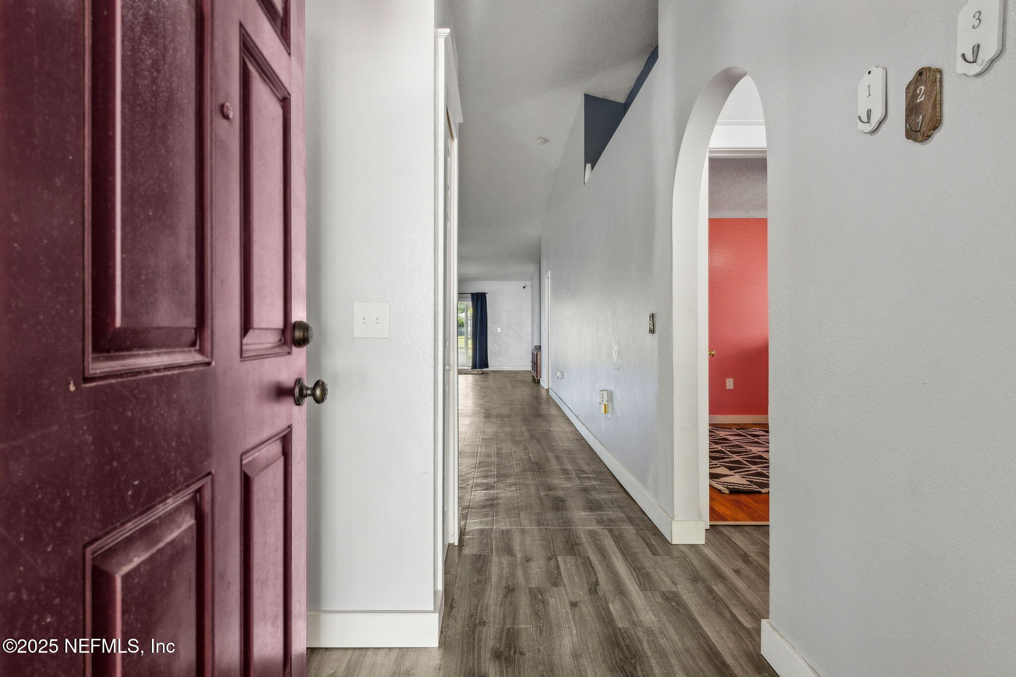 76564 Longleaf Loop Yulee, FL 32097 - Photo 9 of 54 a view of a hallway with entryway and wooden floor