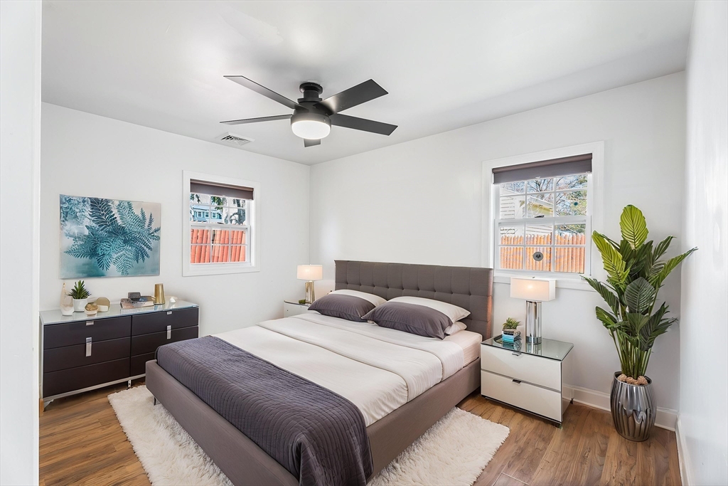 32 Shaw Road Brockton, MA 02301 - Photo 16 of 27 a bedroom with a large bed and a chandelier