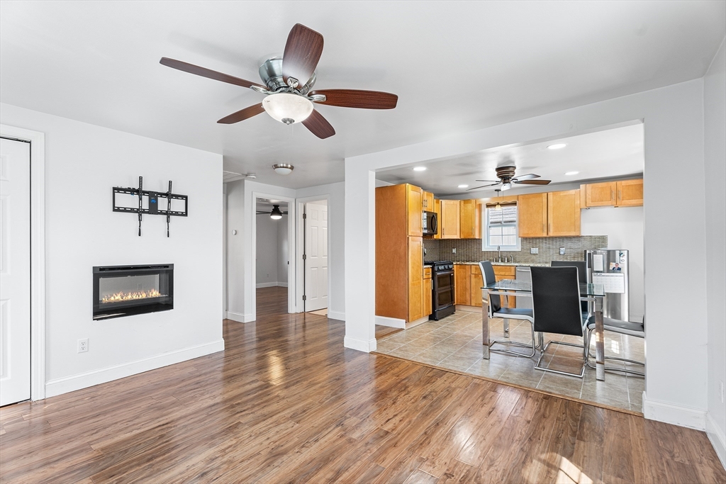 32 Shaw Road Brockton, MA 02301 - Photo 6 of 27 a view of a livingroom with kitchen and wooden floor