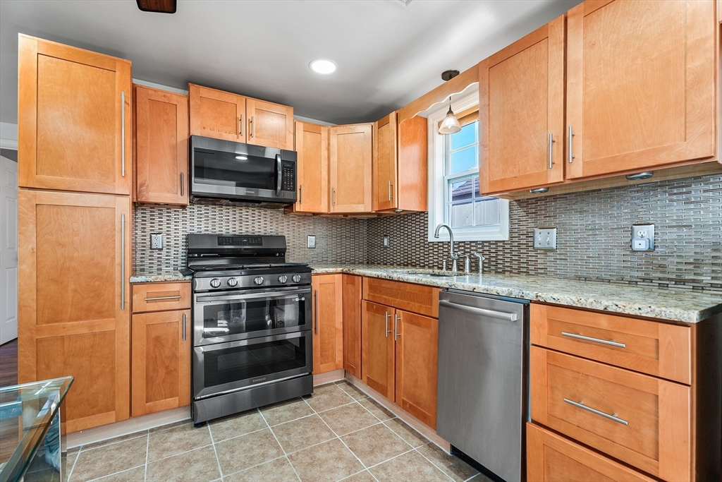 32 Shaw Road Brockton, MA 02301 - Photo 10 of 27 a kitchen with stainless steel appliances granite countertop a stove sink and microwave