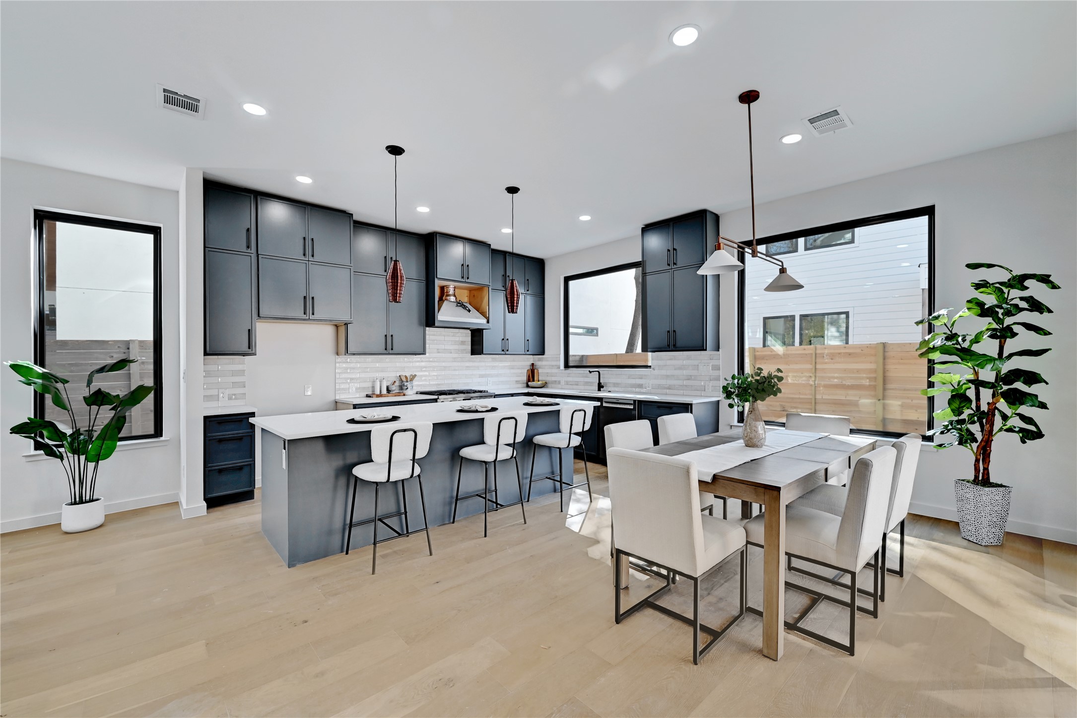 2717 Lyons Road, Unit 1 Austin, TX 78702 - Photo 5 of 34 Kitchen with a kitchen bar, tasteful backsplash, pendant lighting, a kitchen island, and recessed lighting