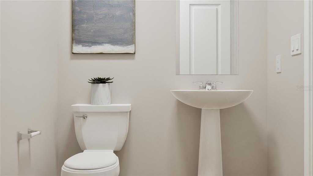 5620 Morant Bay Path Kissimmee, FL 34758 - Photo 23 of 34 a bathroom with a toilet sink and mirror