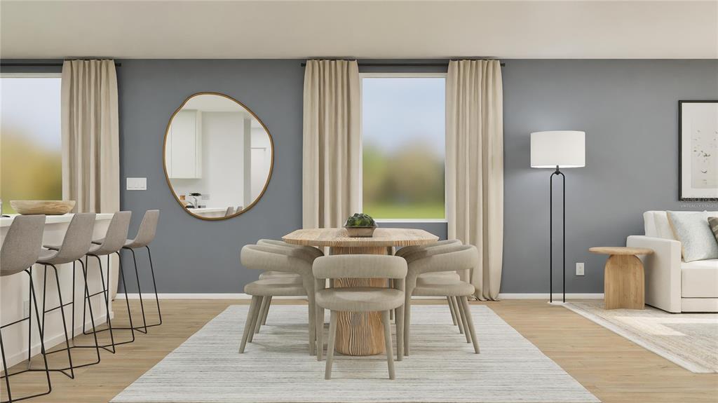 5620 Morant Bay Path Kissimmee, FL 34758 - Photo 5 of 34 a living room with furniture a mirror and a large window