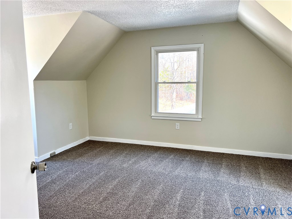 2049 Riddle Road Blackstone, VA 23824 - Photo 20 of 44 an empty room with wooden floor and windows