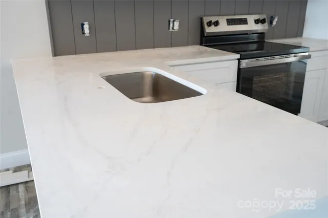 a kitchen with a stove and a refrigerator