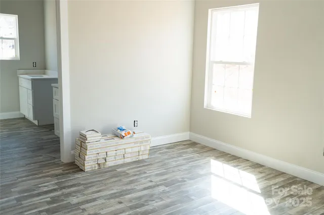 a room with a window and wooden floor