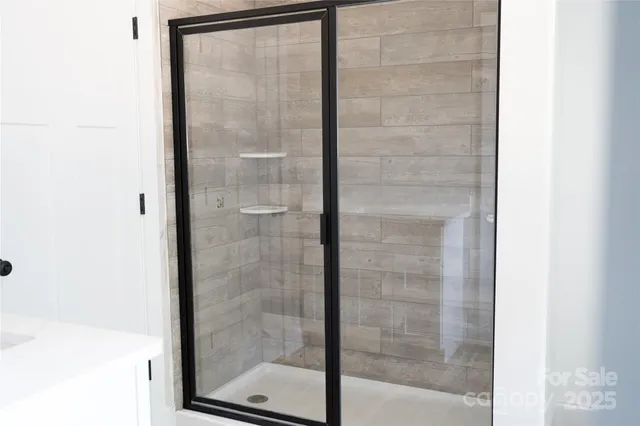 a bathroom with a glass shower door