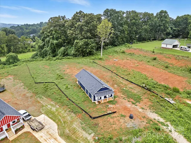a view of a tennis ground with large trees
