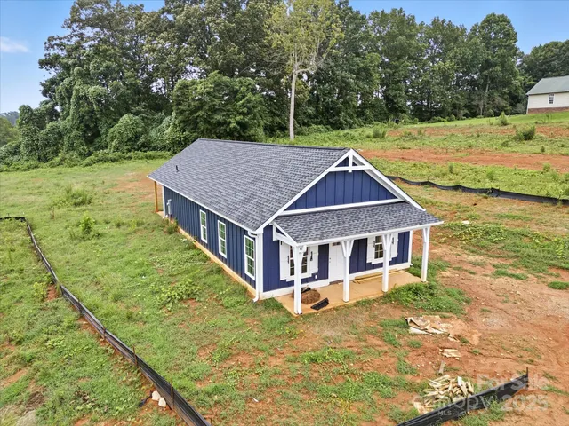 a aerial view of a house with a yard
