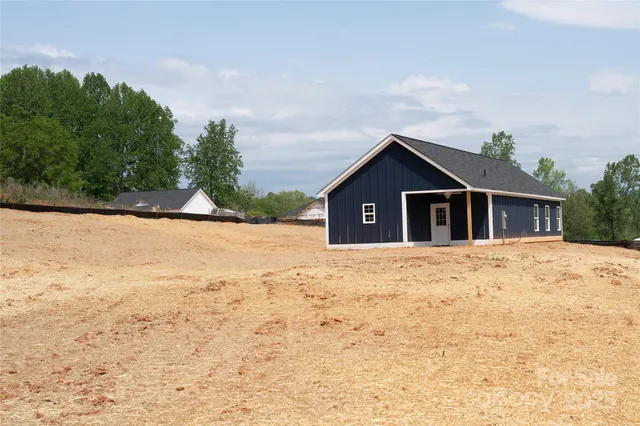 a view of yellow house with a yard
