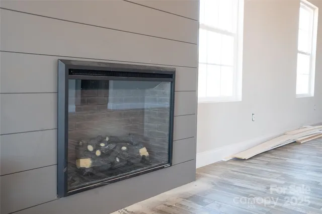 a living room with a wooden floor and a fireplace