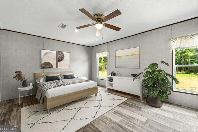 a bedroom with a bed and a large window