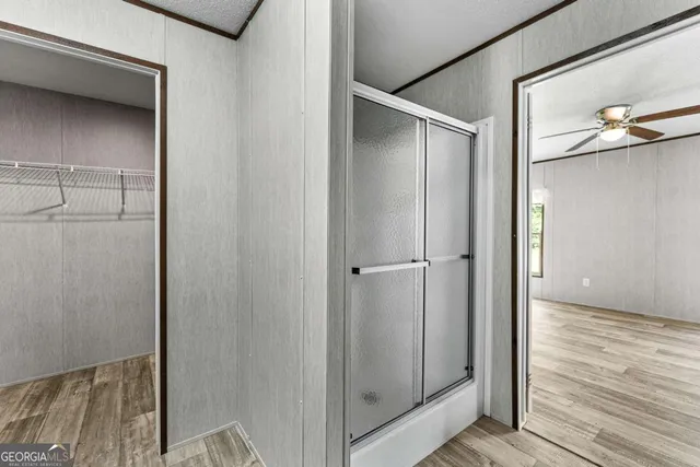 a view of closet area with wooden floor