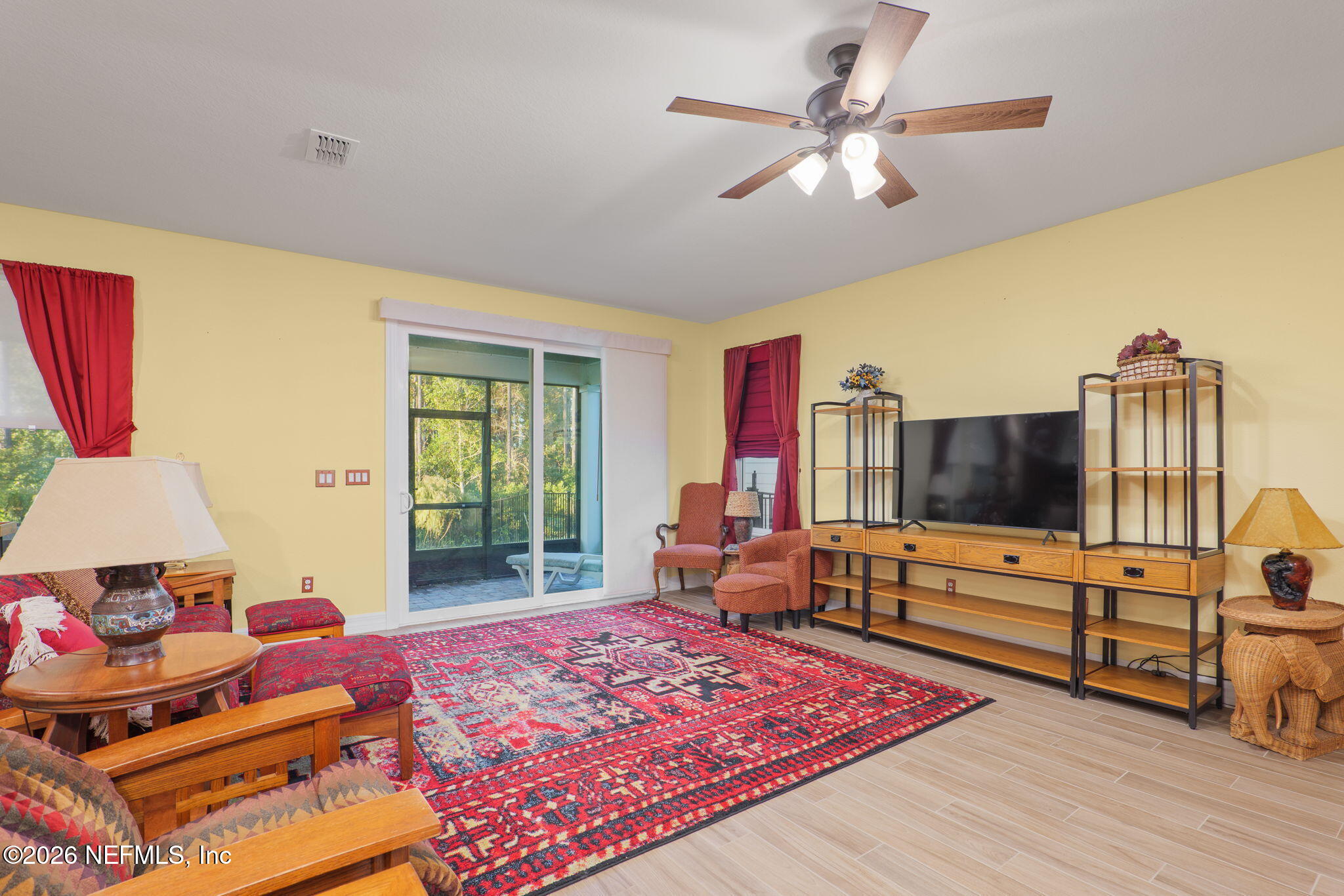 408 Del Webb Parkway Yulee, FL 32097 - Photo 15 of 35 a living room with furniture and a flat screen tv