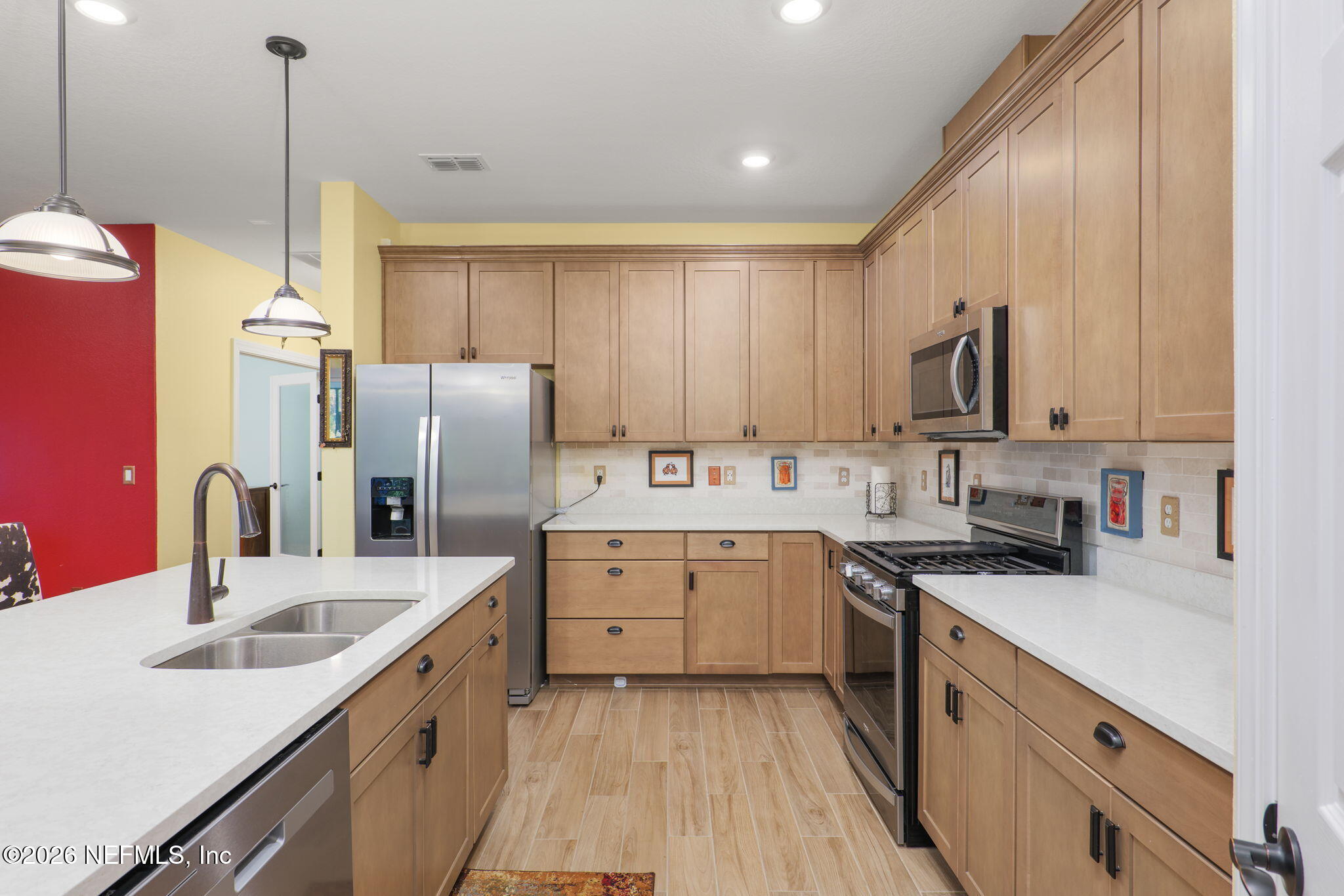 408 Del Webb Parkway Yulee, FL 32097 - Photo 2 of 29 a kitchen with a sink stove and refrigerator