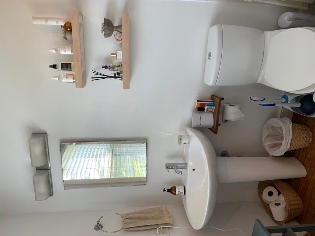 5 Salros Road Nantucket, MA 02554 - Photo 13 of 24 a bathroom with a sink a toilet and a mirror
