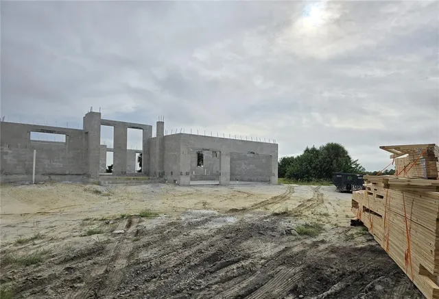 a view of a house with wooden fence