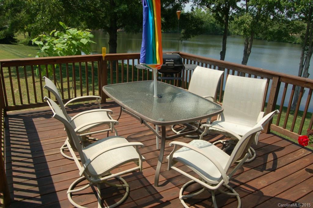 1880 Flat Rock Road York, SC 29745 - Photo 14 of 23 a view of a balcony with two chairs and wooden floor