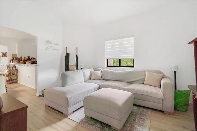 a living room with furniture and a window