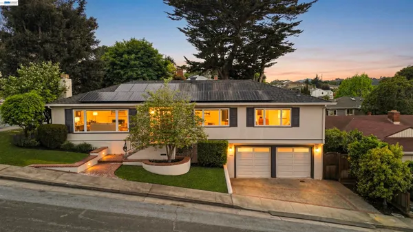 a backyard of a house with yard and outdoor seating