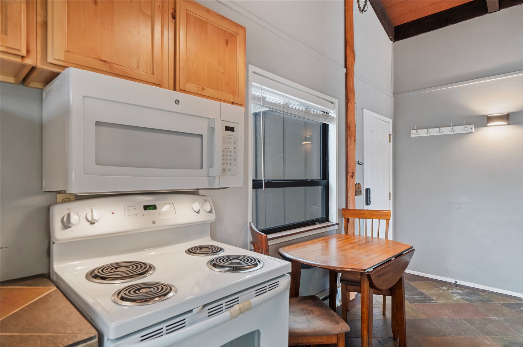 809 Ryan Gulch Road, Unit 809 Silverthorne, CO 80498 - Photo 11 of 18 a kitchen with a stove and a microwave