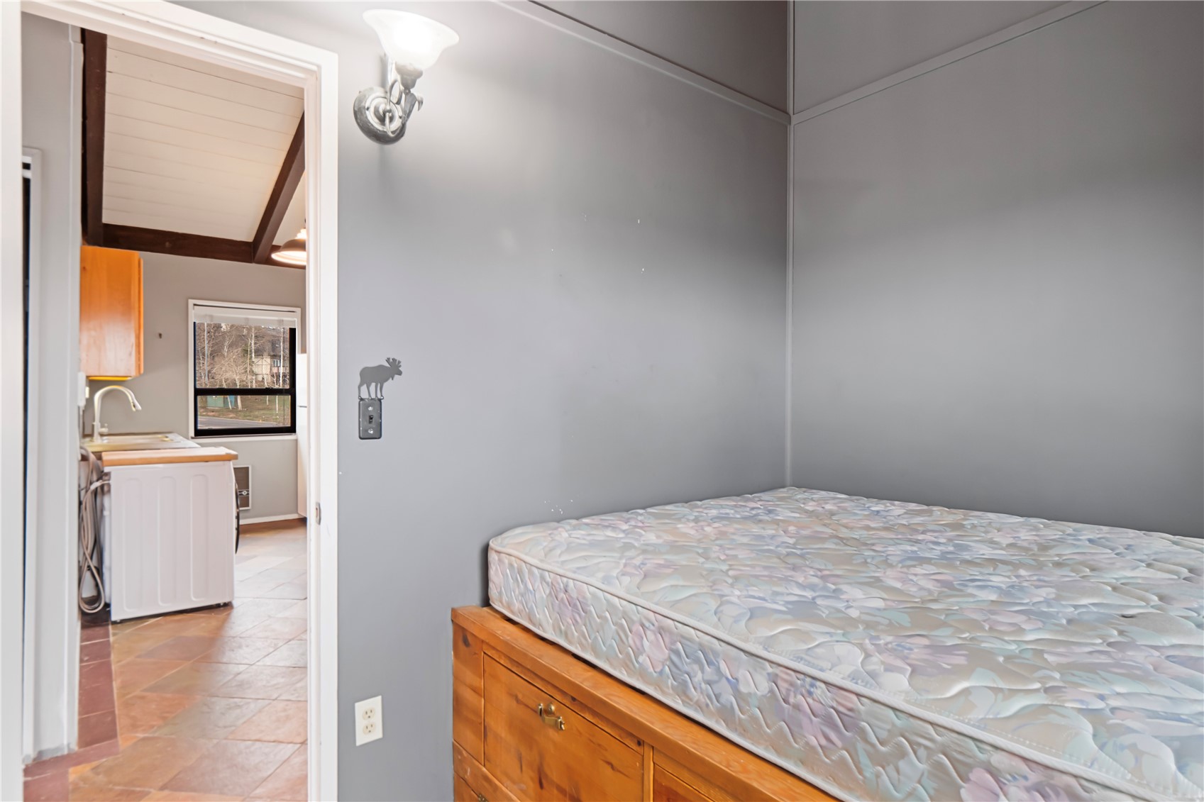 809 Ryan Gulch Road, Unit 809 Silverthorne, CO 80498 - Photo 15 of 18 a bedroom with a bed and a mirror on the dresser