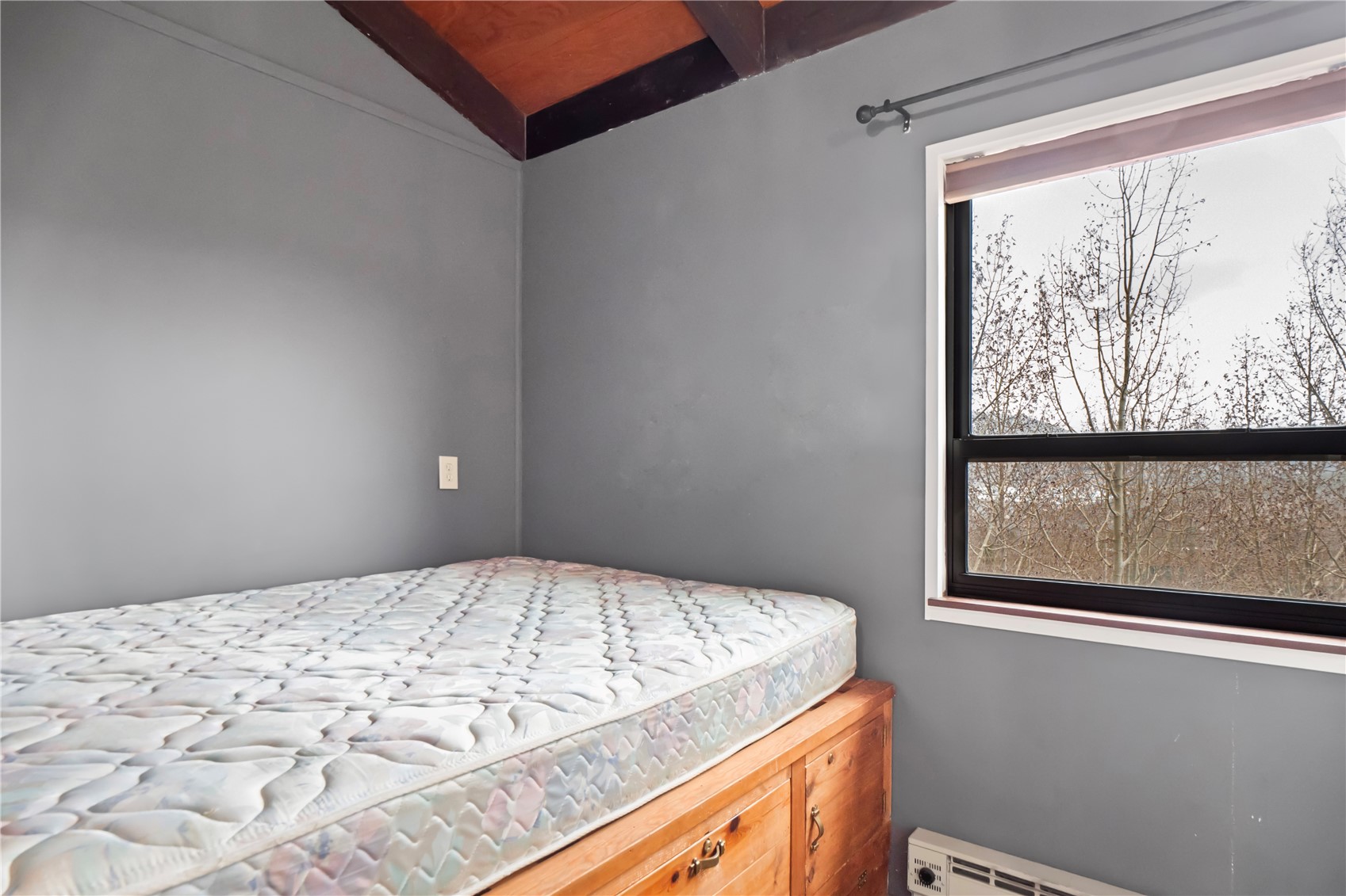 809 Ryan Gulch Road, Unit 809 Silverthorne, CO 80498 - Photo 16 of 18 a bedroom with a bed and a window
