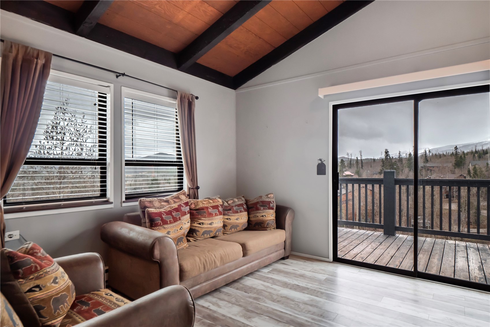 809 Ryan Gulch Road, Unit 809 Silverthorne, CO 80498 - Photo 8 of 18 a living room with furniture and a large window