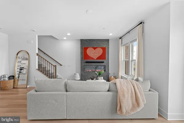 a living room with furniture a window and a flat screen tv