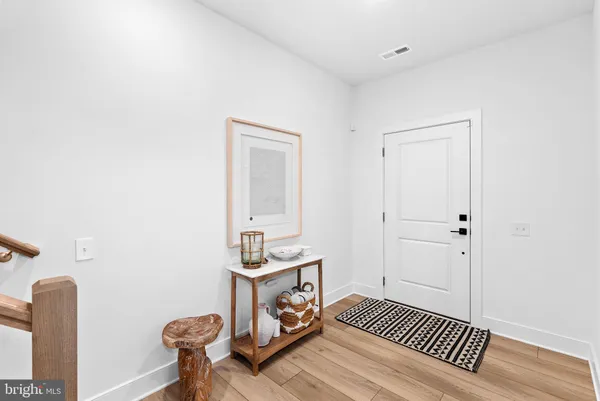a view of a bedroom with wooden floor