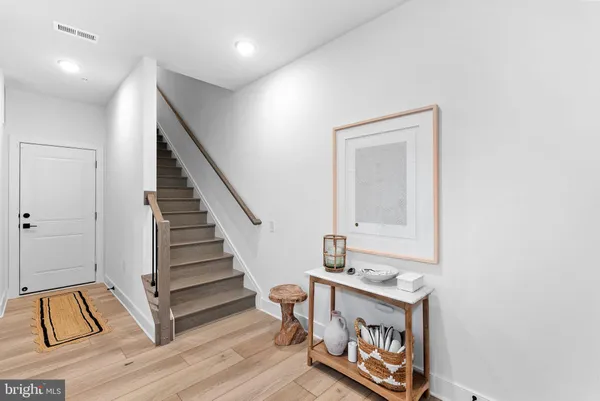 a view of an entryway with wooden floor