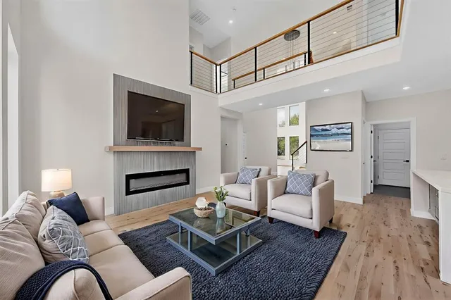 a living room with furniture fireplace and flat screen tv