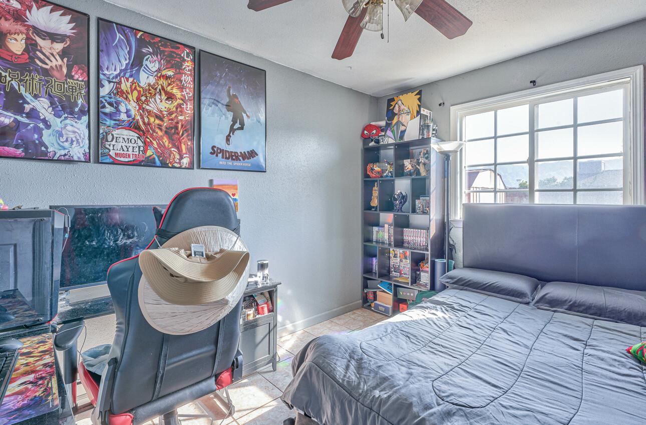 415 Michael Circle Gonzales, CA 93926 - Photo 11 of 16 a bedroom with a bed and a chandelier