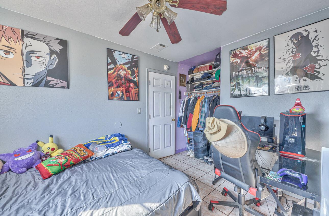 415 Michael Circle Gonzales, CA 93926 - Photo 12 of 16 a bedroom with a bed a bookshelf and wooden floor