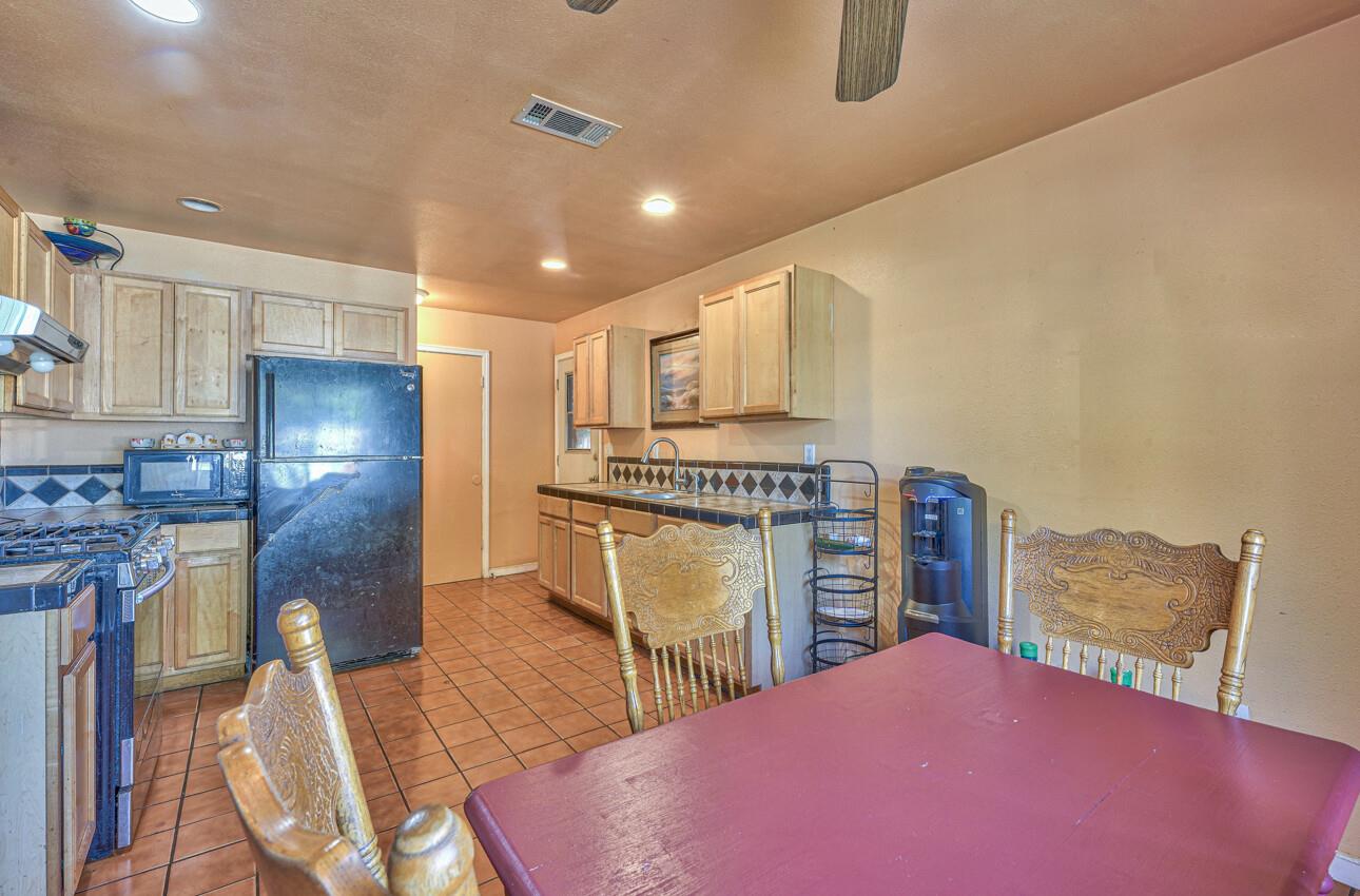 415 Michael Circle Gonzales, CA 93926 - Photo 5 of 16 a kitchen with stainless steel appliances kitchen island granite countertop a refrigerator and stove