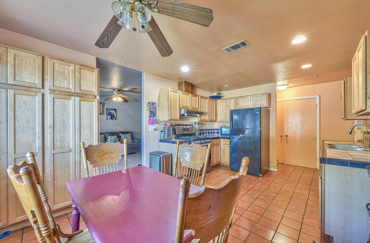 415 Michael Circle Gonzales, CA 93926 - Photo 6 of 16 a kitchen with stainless steel appliances kitchen island granite countertop a refrigerator and microwave