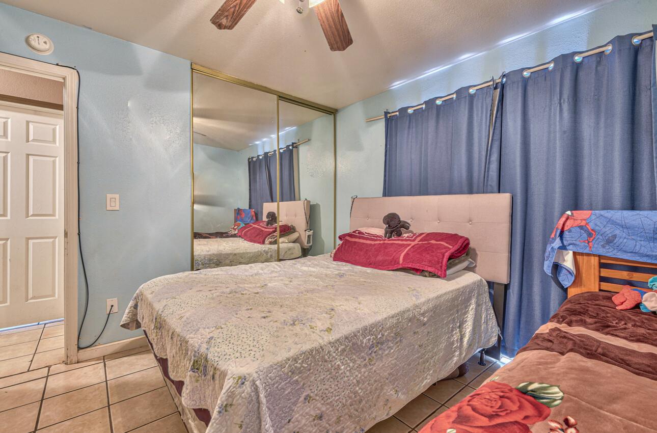 415 Michael Circle Gonzales, CA 93926 - Photo 10 of 16 a bedroom with a bed and wooden floor