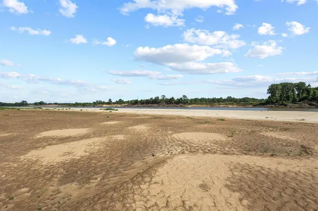 a view of a lake with houses in the background