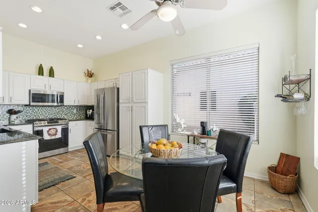 a bedroom with a bed a chandelier and flat screen tv