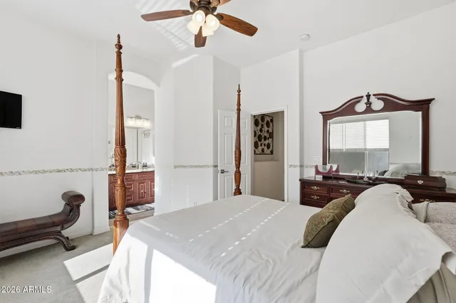 a living room with furniture a flat screen tv and a window