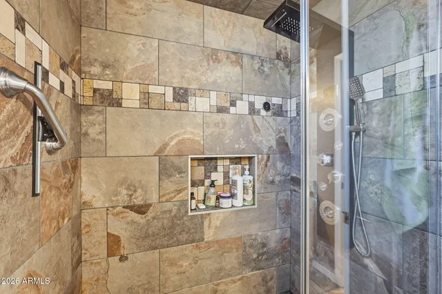 a bedroom with a bed and a painting on the wall