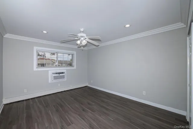 a view of a room with wooden floor and window