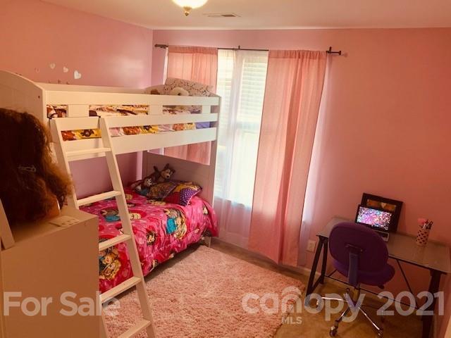 919 Azurine Circle Fort Mill, SC 29708 - Photo 18 of 19 a bedroom with a bed and wooden floor