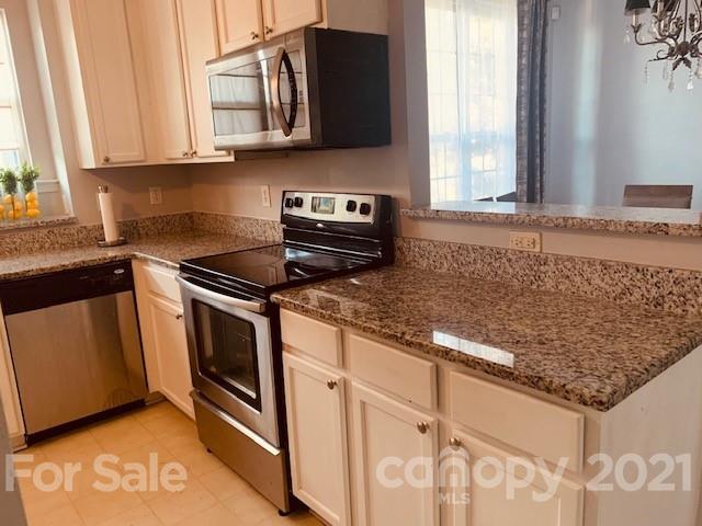 919 Azurine Circle Fort Mill, SC 29708 - Photo 7 of 19 a kitchen with stainless steel appliances granite countertop a sink stove and microwave