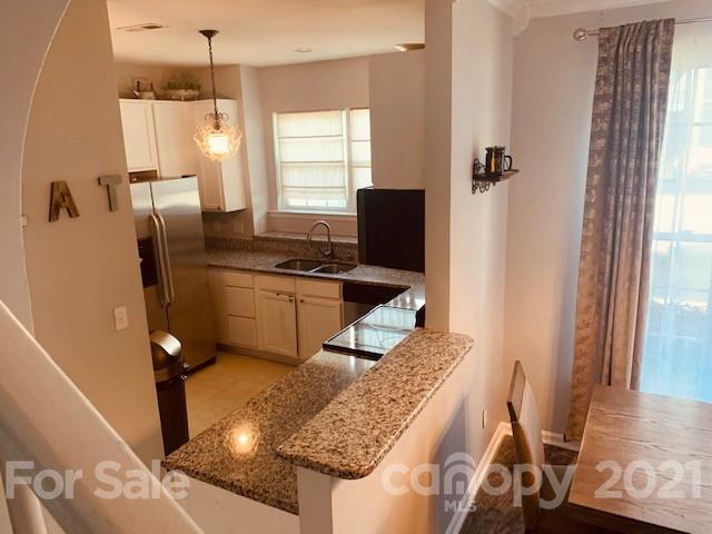 919 Azurine Circle Fort Mill, SC 29708 - Photo 9 of 19 a kitchen with stainless steel appliances granite countertop a sink refrigerator and window