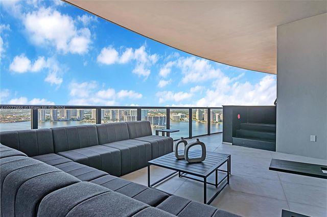 a living room with furniture a rug and a flat screen tv