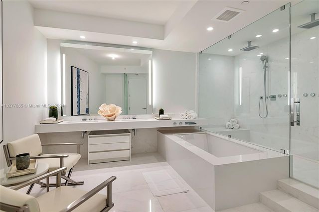 a large bathroom with a double vanity sink mirror and a bathtub