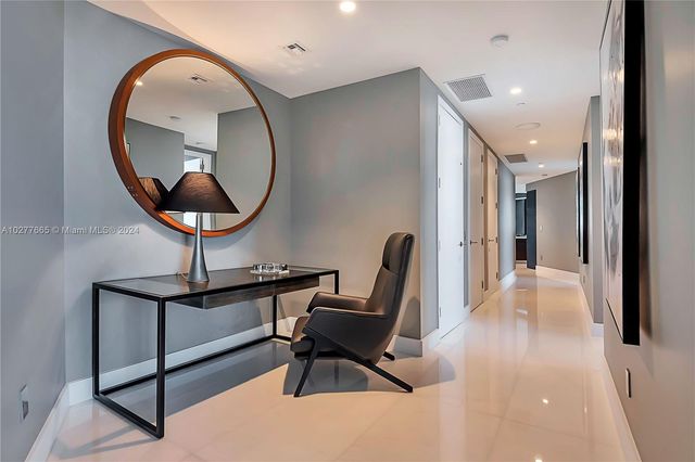 a view of a livingroom with furniture and a mirror